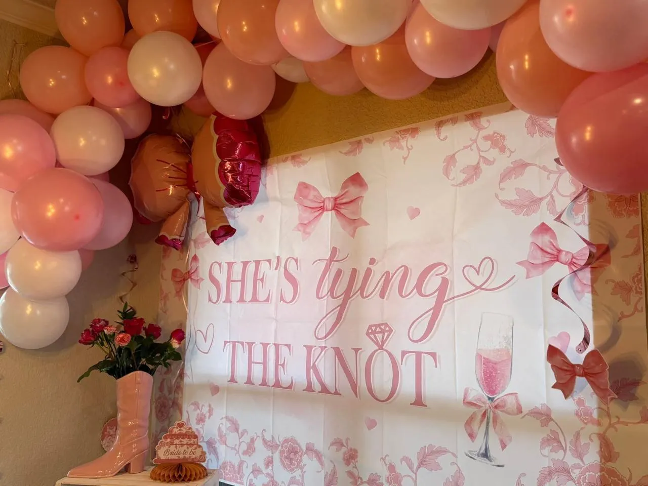 Pink bridal shower backdrop with a balloon arch